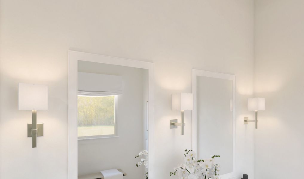 White-framed mirrors and lights with linen shades in the primary bath