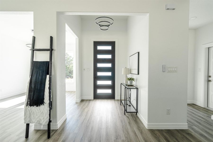 Entrance foyer featuring light wood finished floors and baseboards