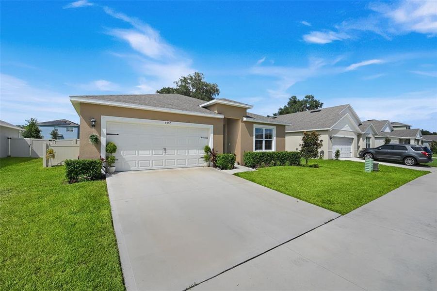 Front exterior of a new home in Windrose, Apopka, FL, highlighting curb appeal (Image 21).