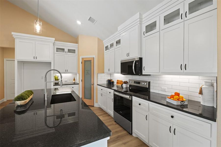 Kitchen featuring an expansive island with an undermount sink and a gooseneck faucet Kitchen featuring an expansive island with an undermount sink and a gooseneck faucet