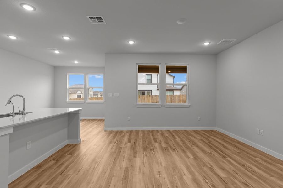 A kitchen with a wood floor. A kitchen with a wood floor.