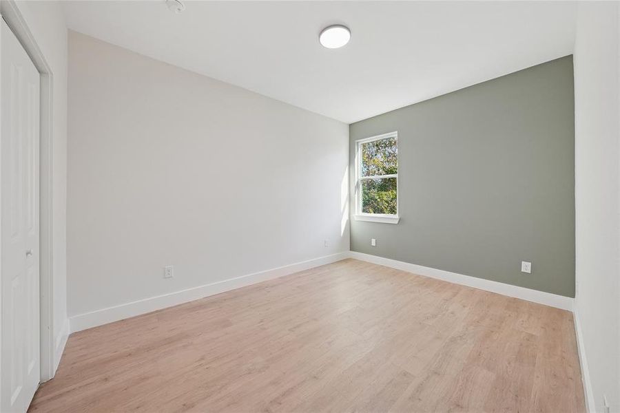 Empty room featuring light wood-style floors and baseboards