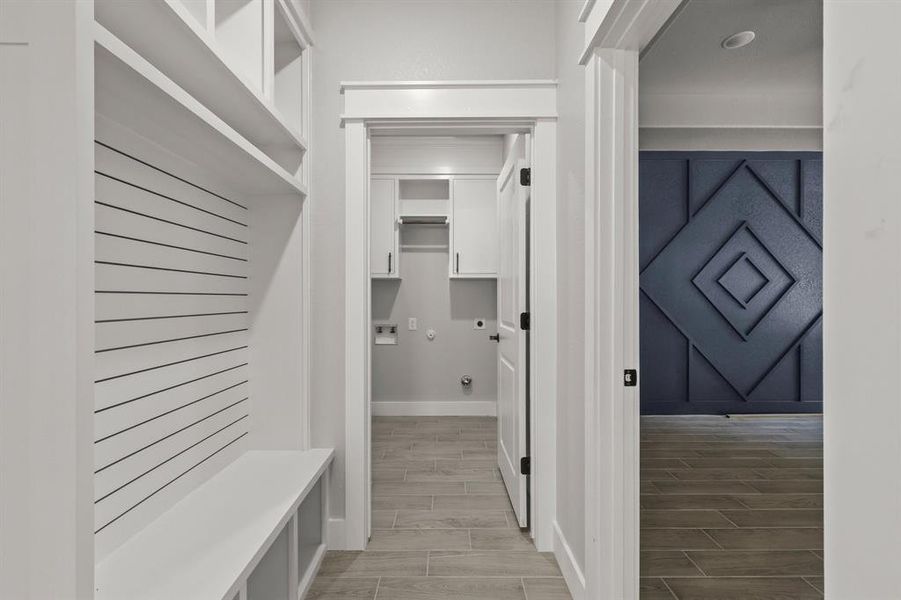 Mudroom with baseboards and wood tiled floors