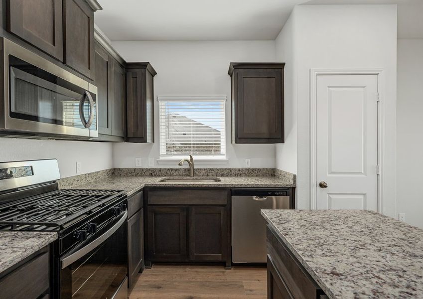 The kitchen has beautiful wood cabinetry.