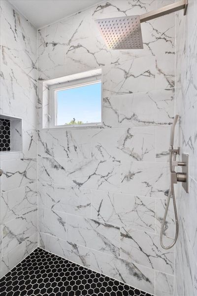 Marble-inspired tiling creates a luxurious shower retreat.