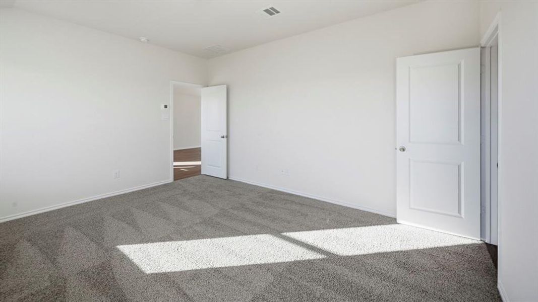 Unfurnished room with carpet flooring and baseboards Unfurnished room with carpet flooring and baseboards
