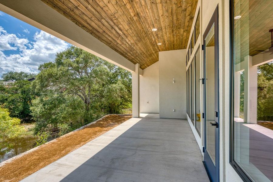 Experience serene outdoor living on this elevated patio, offering panoramic views of the surrounding natural landscape.