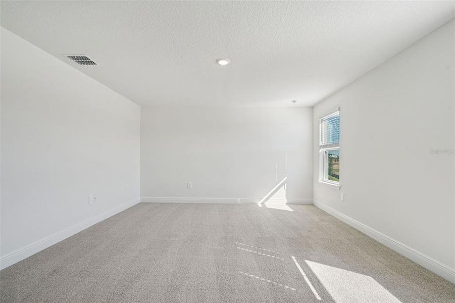 Spacious, unfurnished interior of a new home in The Reserve at Hammock Oaks - Signature Series, Lady Lake (Image 17).