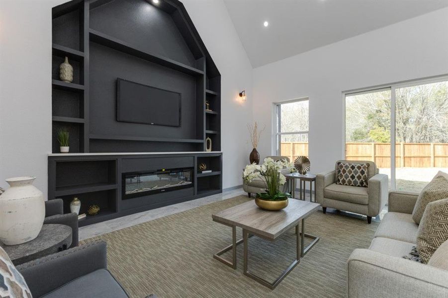 Living room featuring high vaulted ceiling and built in features