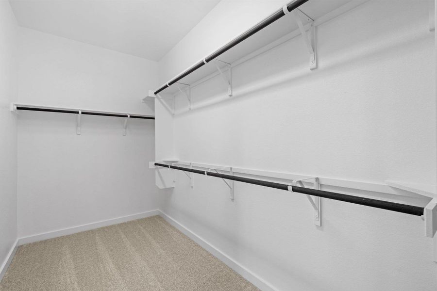 Walk-in closet in Primary Bedroom Walk-in closet in Primary Bedroom