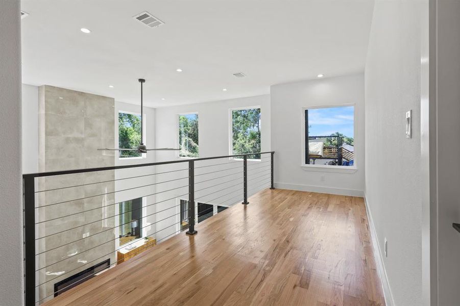 Hallway with light hardwood / wood-style flooring