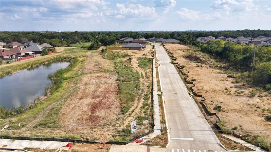 Aerial perspective of suburban area with a large body of water