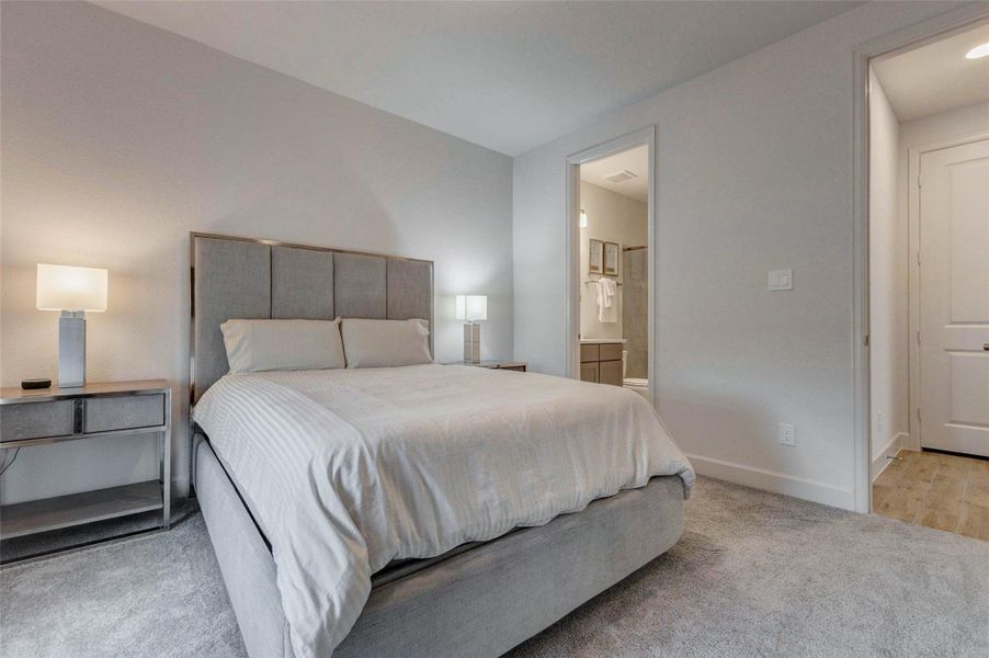 Cozy secondary bedroom with in suite bath located on the main floor. Neutral tones create a calming atmosphere. Ideal for guests or occupants that prefers not going up and down stairs. Cozy secondary bedroom with in suite bath located on the main floor. Neutral tones create a calming atmosphere. Ideal for guests or occupants that prefers not going up and down stairs.