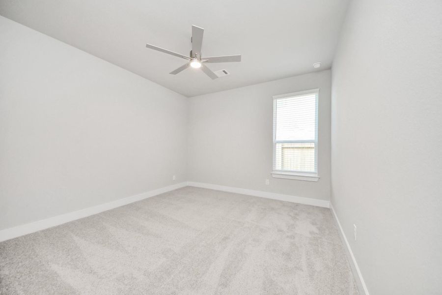 Generously sized secondary bedrooms featuring spacious closets, soft and inviting carpeting underfoot, large windows allowing plenty of natural light, and the added touch of privacy blinds for your personal retreat. Sample photo of completed home with similar floor plan. Actual colors and selections may vary.
