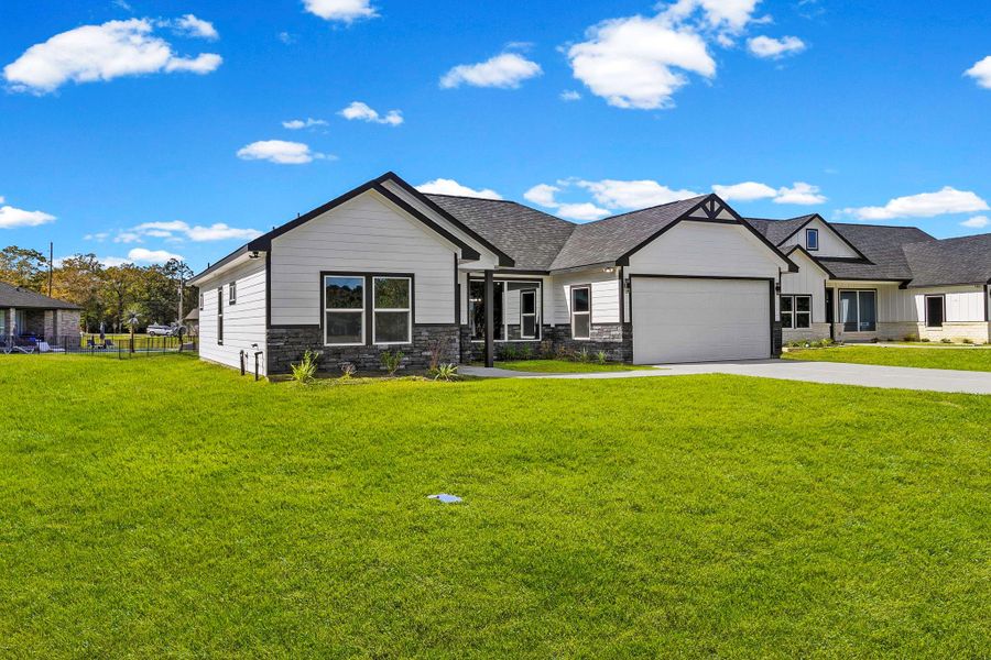Front exterior of a new home in , Trinity, TX, highlighting curb appeal (Image 1).