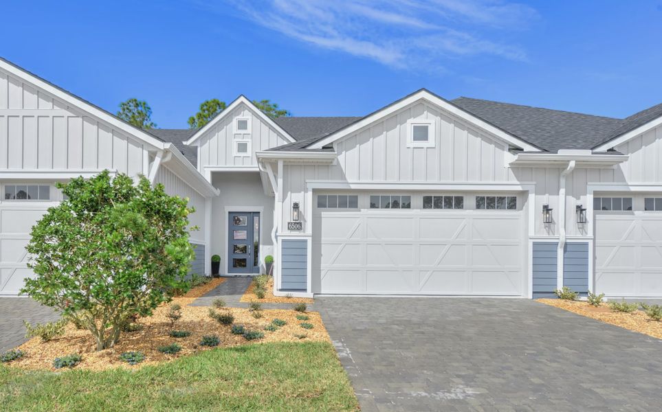 Front exterior of a new home in Woodhaven, Port Orange, FL, highlighting curb appeal (Image 2).