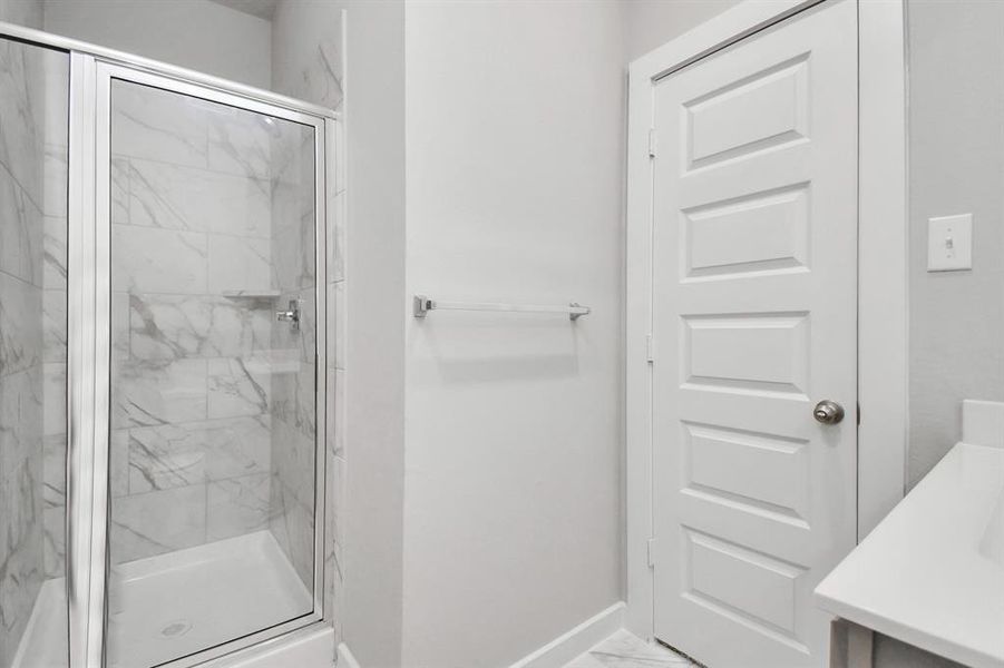 Walk in shower in guest suite.  Representation of completed home with similar plan. Actual color and selections will vary.