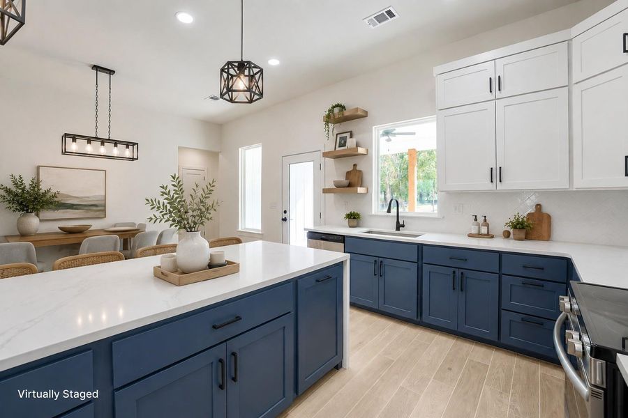 Culinary excellence awaits in this well-lit kitchen, featuring a spacious island and ample counter space.