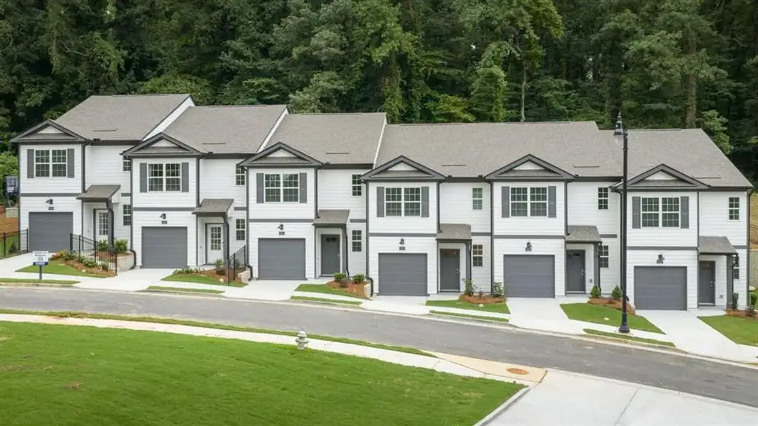 Front exterior of a new home in Towns at Monroe, Atlanta, GA, highlighting curb appeal (Image 1). Front exterior of a new home in Towns at Monroe, Atlanta, GA, highlighting curb appeal (Image 1).