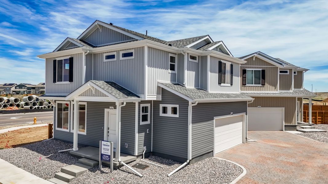 Front exterior of a new home in Reunion, Commerce City, CO, highlighting curb appeal (Image 24). Front exterior of a new home in Reunion, Commerce City, CO, highlighting curb appeal (Image 24).