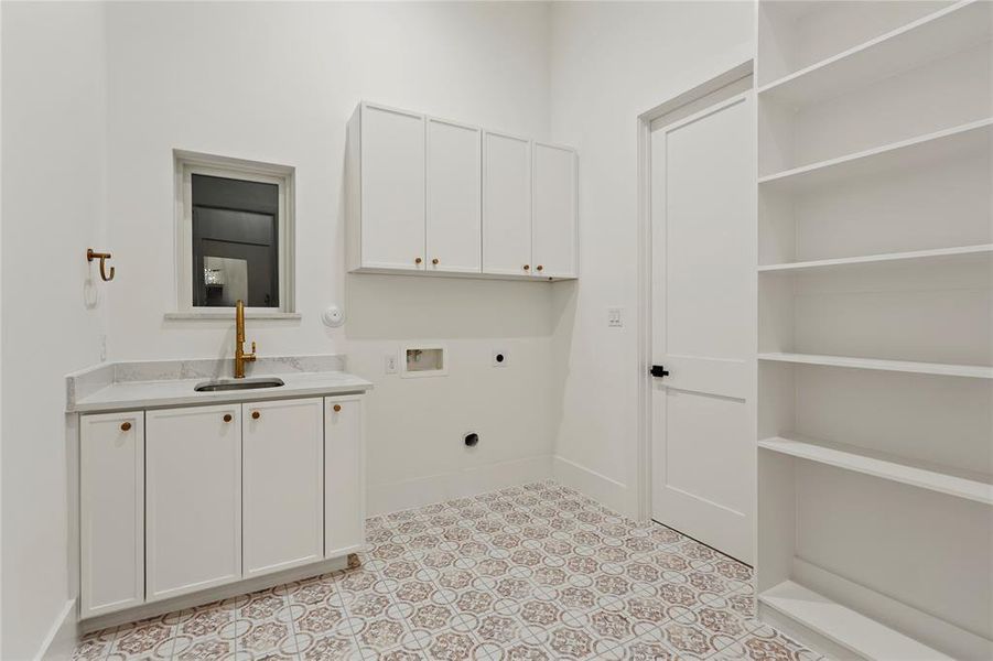 Washroom with washer hookup, electric dryer hookup, cabinet space, and light floors