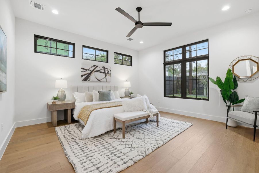 Bedroom featuring light wood finished floors, a ceiling fan, and recessed lighting