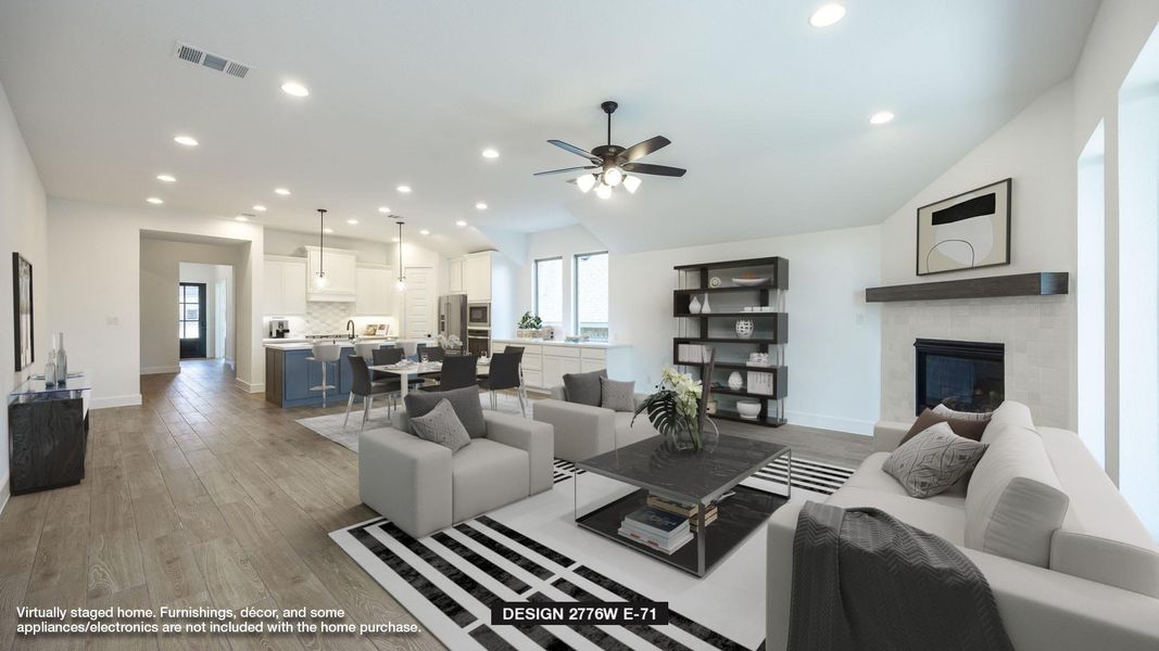 Living room with a ceiling fan, lofted ceiling, light wood-style flooring, a tiled fireplace, and recessed lighting Living room with a ceiling fan, lofted ceiling, light wood-style flooring, a tiled fireplace, and recessed lighting