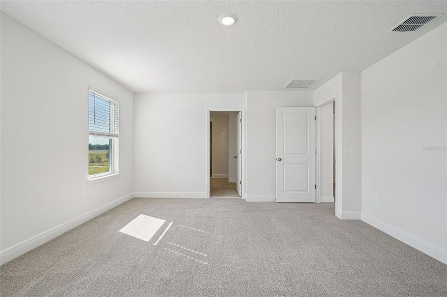 Spacious, unfurnished interior of a new home in The Reserve at Hammock Oaks - Signature Series, Lady Lake (Image 24).