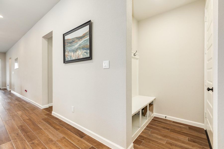 Across the hall from the guest suite, you'll find the mud area, complete with storage space and direct access to your spacious, true 3-car garage. The next hallway on your right leads to two secondary bedrooms and a bath. Across the hall from the guest suite, you'll find the mud area, complete with storage space and direct access to your spacious, true 3-car garage. The next hallway on your right leads to two secondary bedrooms and a bath.