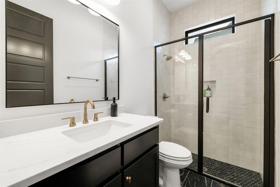 Full bathroom featuring vanity and a stall shower Full bathroom featuring vanity and a stall shower