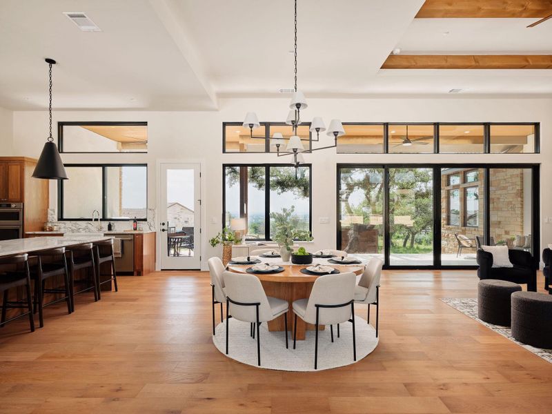 Natural light pours into this open concept living space, highlighted by expansive floor-to-ceiling windows. Natural light pours into this open concept living space, highlighted by expansive floor-to-ceiling windows.