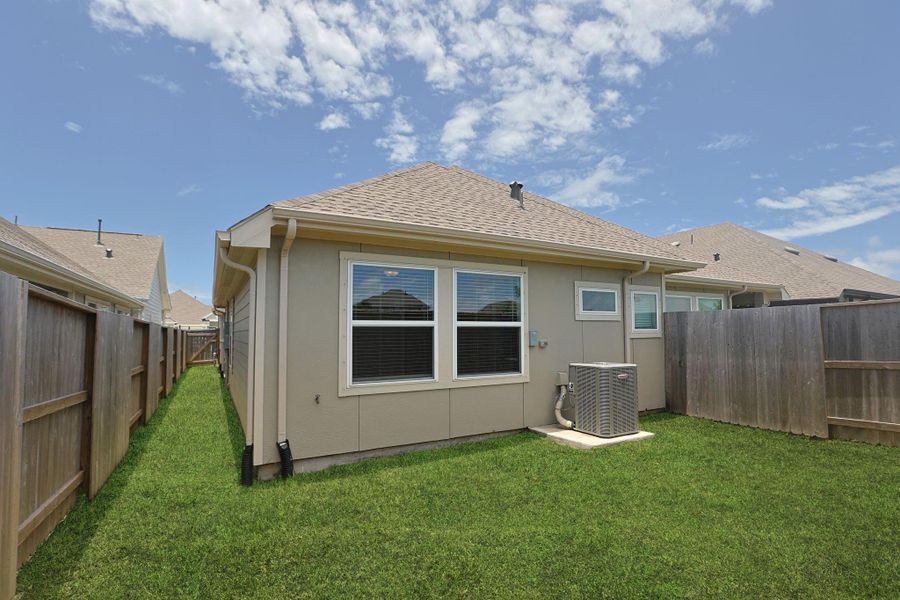 Fully fenced back yard has room to play.