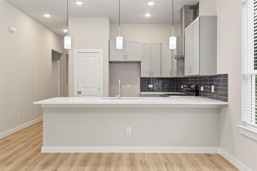 A stunning kitchen with stainless steel appliances, sleek gray cabinetry, and abundant natural light—viewed from a fresh angle. A stunning kitchen with stainless steel appliances, sleek gray cabinetry, and abundant natural light—viewed from a fresh angle.