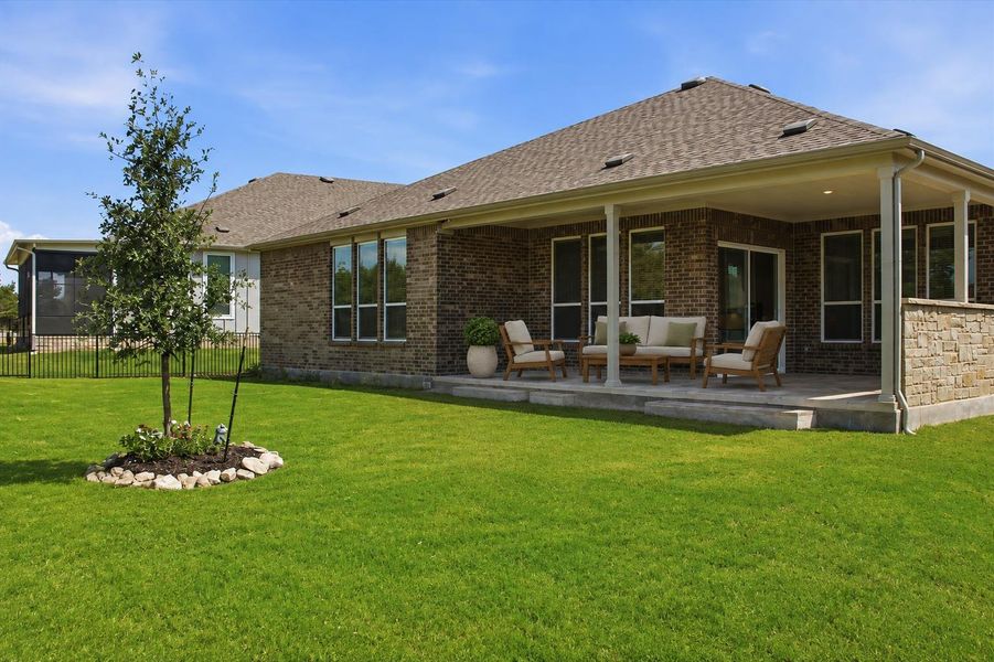 A verdant lawn gracefully transitions to a covered outdoor patio, perfect for leisurely outdoor living. A verdant lawn gracefully transitions to a covered outdoor patio, perfect for leisurely outdoor living.