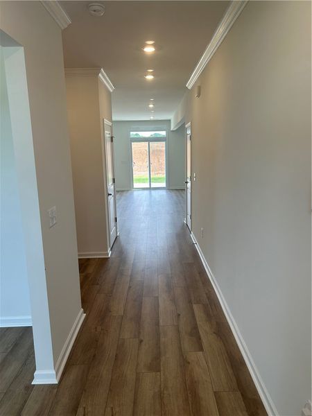 Rich hardwood-style flooring extends through this