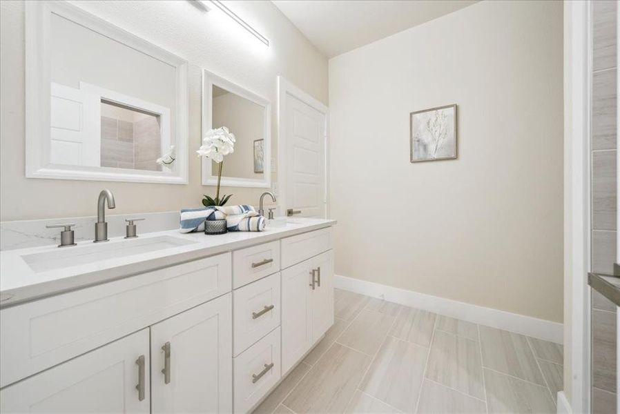 Bathroom featuring tile patterned floors and vanity