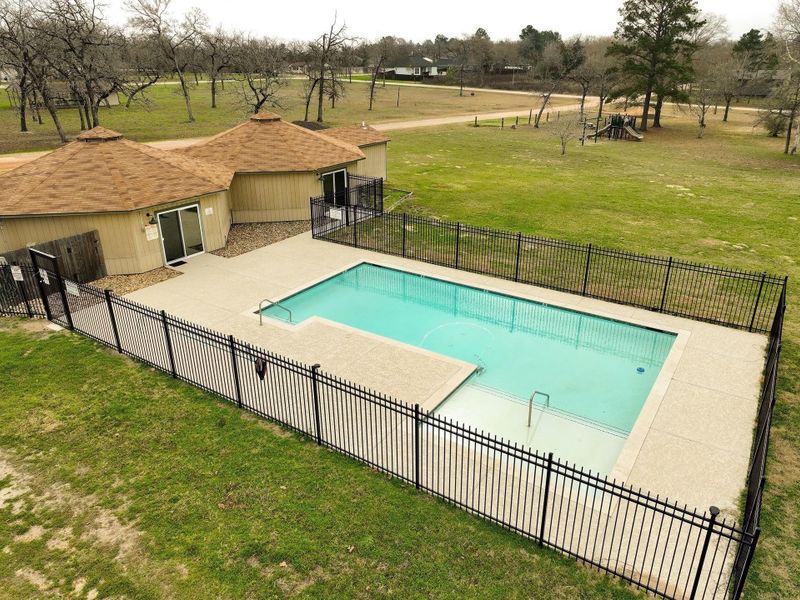 The fenced-in pool area with a rectangular pool, sits adjacent to club house. Summer fun is on the way!