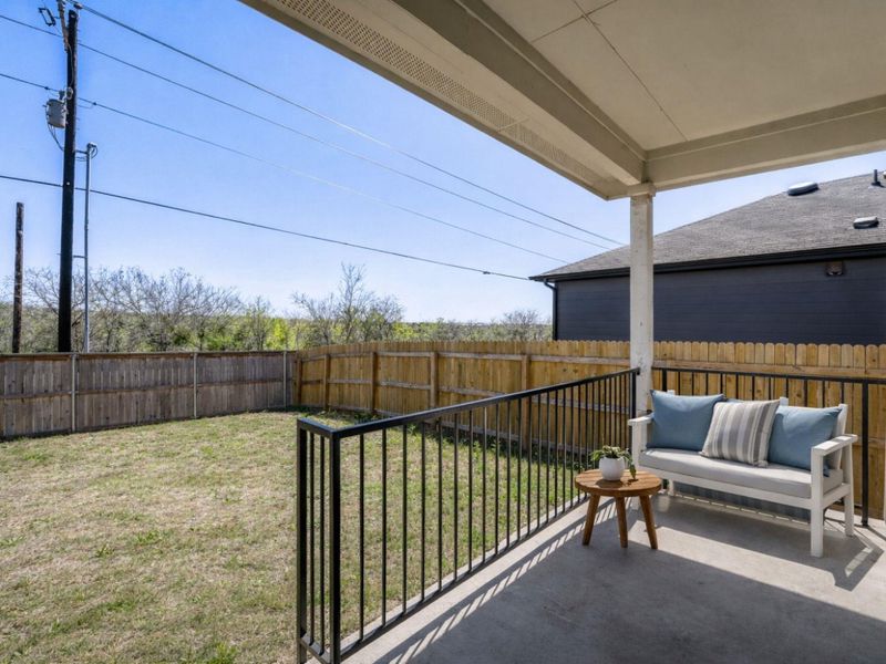 Fenced backyard with a patio area and outdoor seating