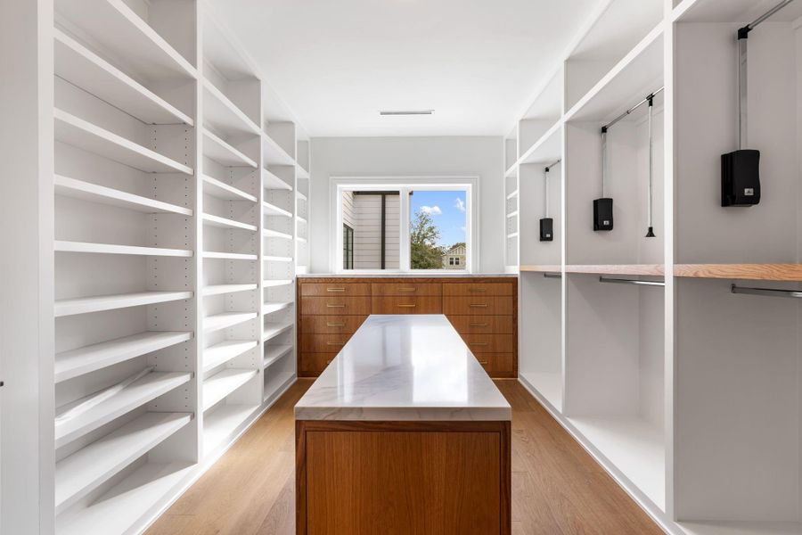Massive walk-in close with custom cabinetry and built-ins.