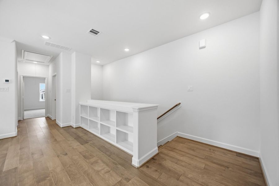 Entertainer's Nook: This game room is perfectly appointed with built-in shelves to showcase your interests and a ceiling fan above to ensure a cool, inviting atmosphere for every play.