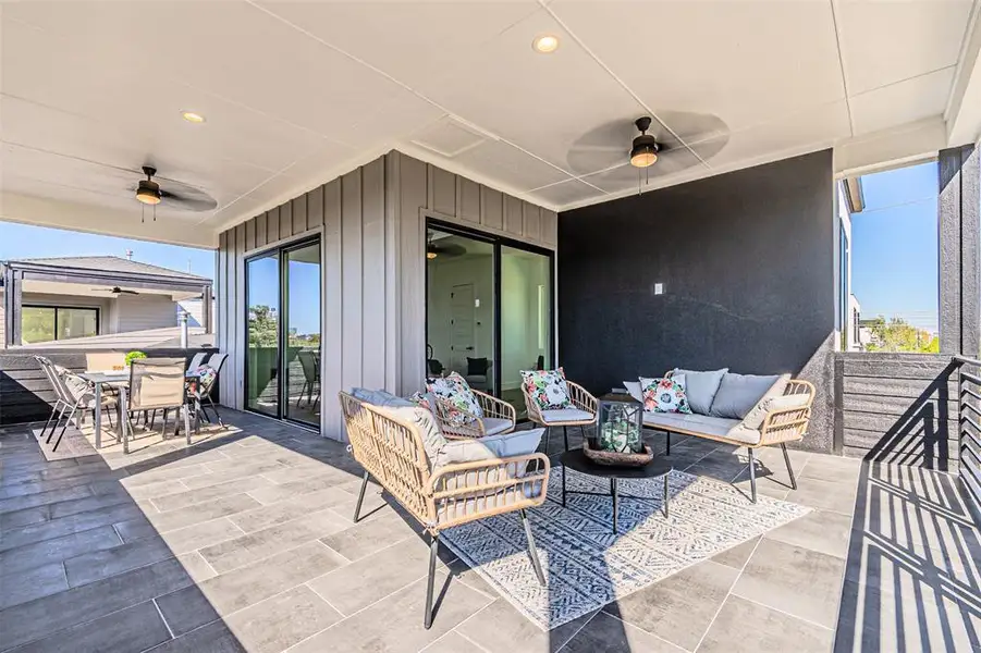 View of patio featuring a ceiling fan, an outdoor hangout area, and outdoor dining space View of patio featuring a ceiling fan, an outdoor hangout area, and outdoor dining space