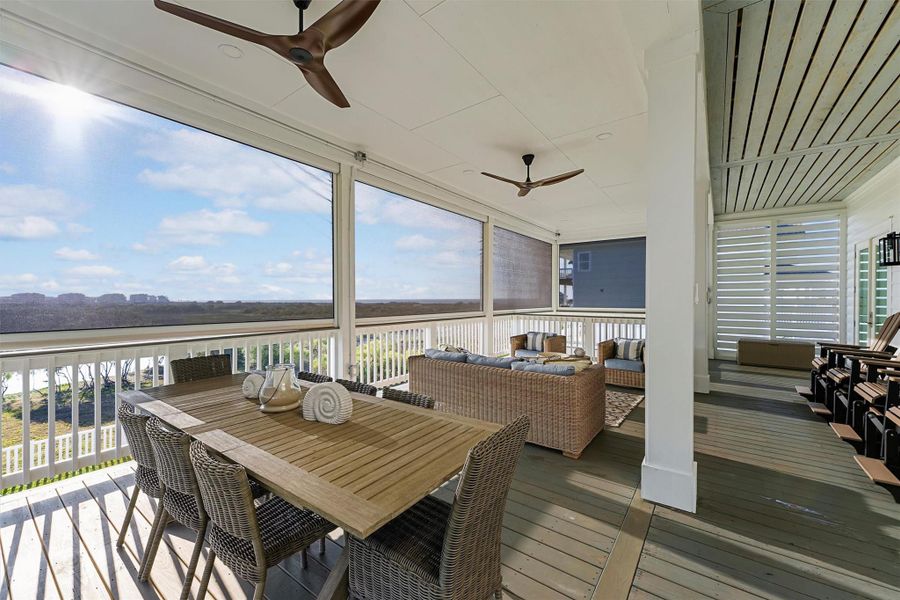 Cozy seating and dining areas with a scenic view, perfect for relaxation and entertaining. Enjoy relaxing, dining or even gliding on the weather resistant polywood chairs across the covered decking.