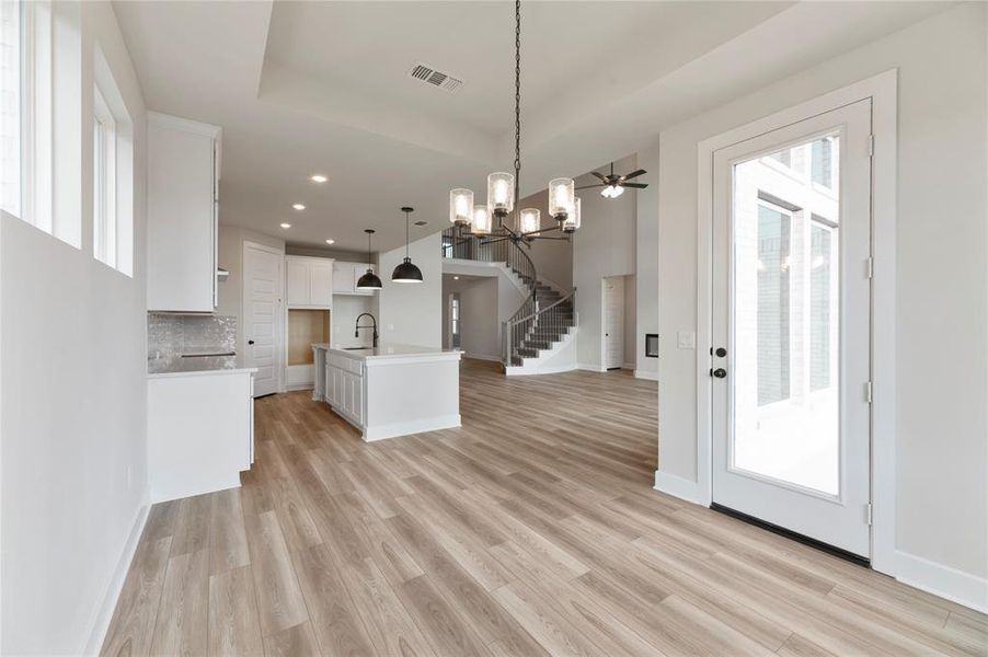 Kitchen with a chandelier, plenty of natural light, open floor plan, hanging light fixtures, and recessed lighting