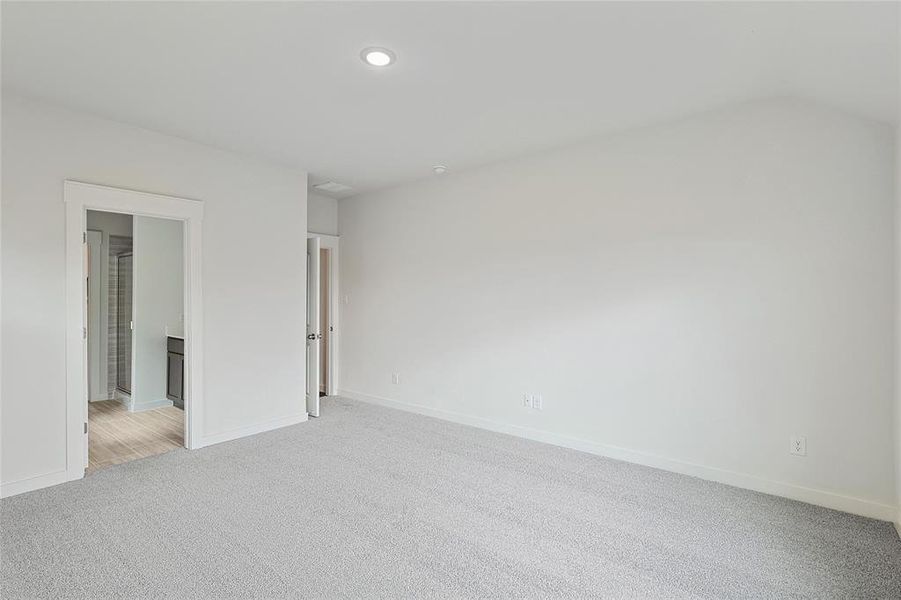 Unfurnished bedroom featuring light colored carpet