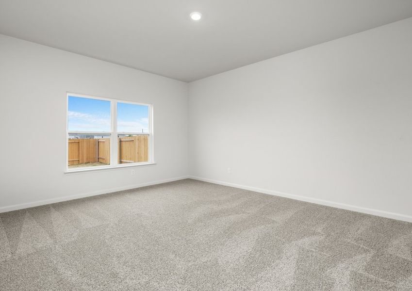 The master bedroom has a large window that lets in natural light and backyard views. The master bedroom has a large window that lets in natural light and backyard views.