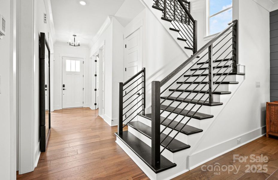 Open Staircase with Wood Treads and Light Filled Landing.  Representative Photo.