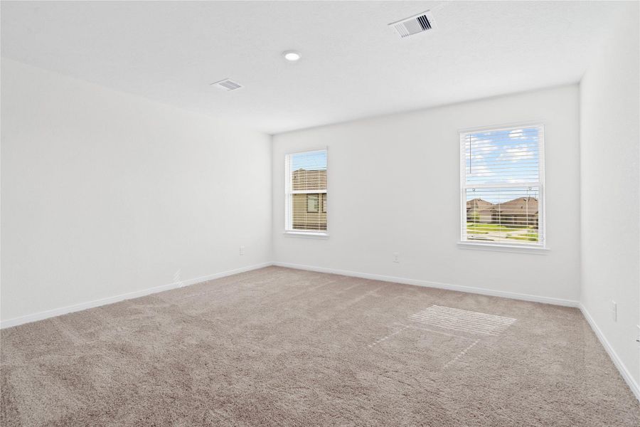 Upstairs, you will find the stunning primary bedroom suite. This spacious retreat features plush carpeting, warm-toned walls, high ceilings, recessed lighting, and large windows with privacy blinds for comfort and tranquility. Upstairs, you will find the stunning primary bedroom suite. This spacious retreat features plush carpeting, warm-toned walls, high ceilings, recessed lighting, and large windows with privacy blinds for comfort and tranquility.