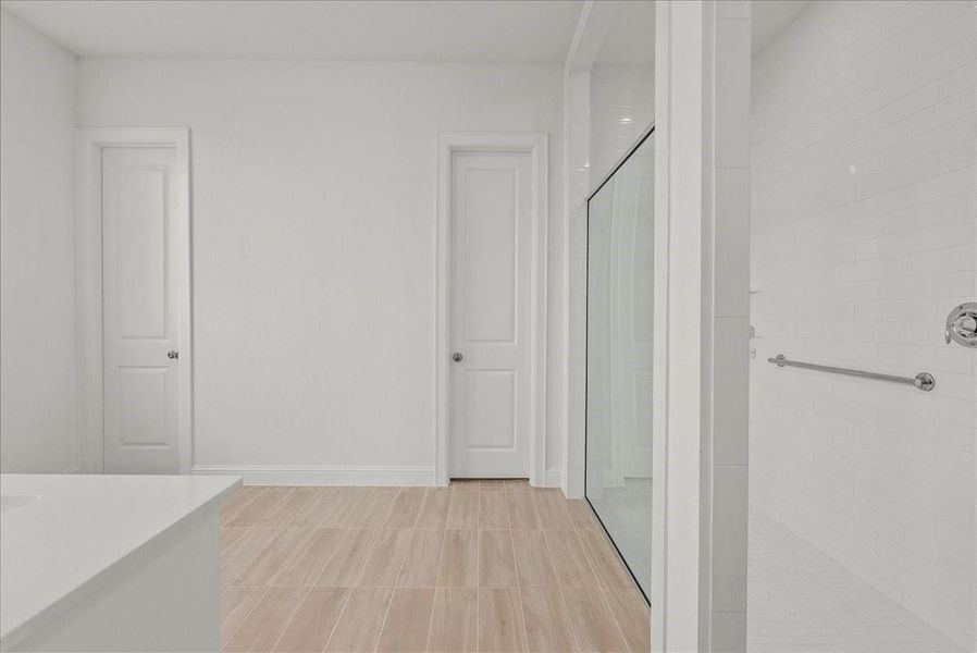 Spa-like en-suite bath with an oversized walk-in shower, double sinks, and a generous walk-in closet. Spa-like en-suite bath with an oversized walk-in shower, double sinks, and a generous walk-in closet.