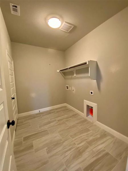Large laundry room has room for a washer & dryer and a dedicated plug for 2nd fridge or freezer.