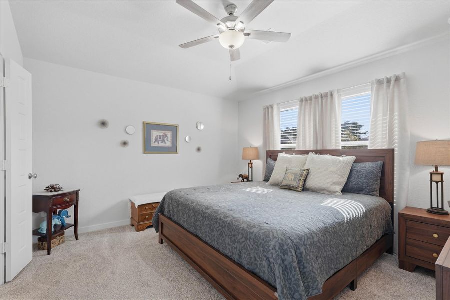 The spacious primary bedroom offers a peaceful retreat with a walk-in closet, plenty of natural light, and more than enough space for a complete furniture set.